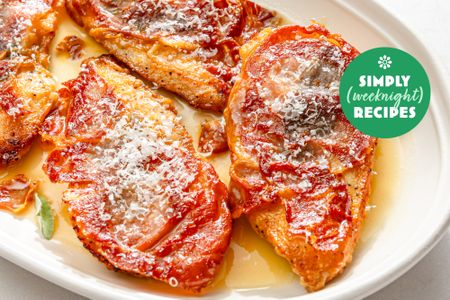 Chicken cutlets topped with tomato and cheese on a white plate with Simply Weeknight Recipes logo visible
