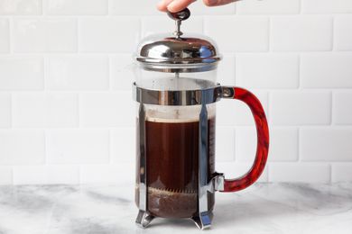 French Press Covered with Lid and Plunger Pushed Down for French Press Coffee Recipe 