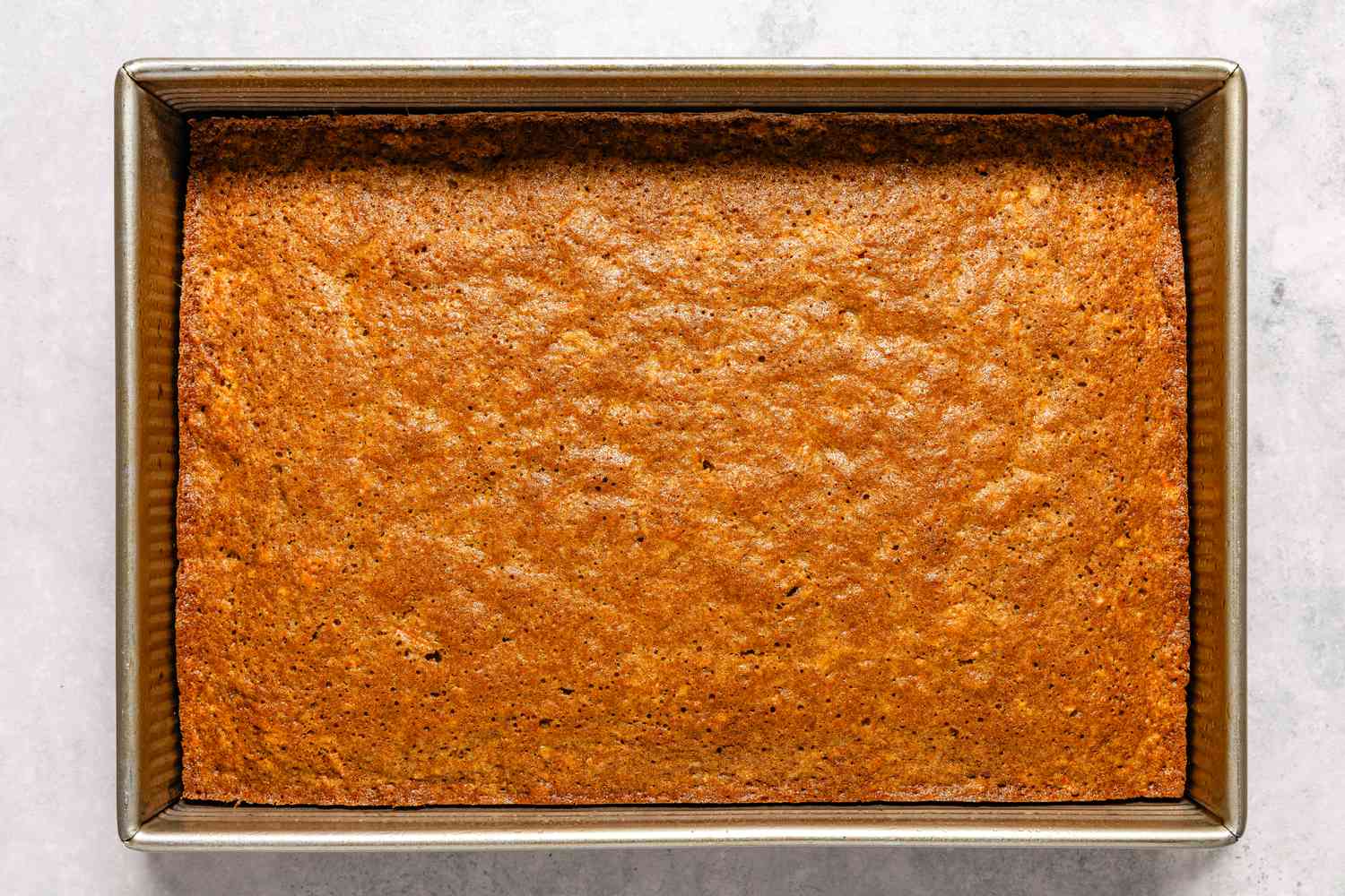 Baked carrot cake from Easy Carrot Cake recipe in a rectangular pan.