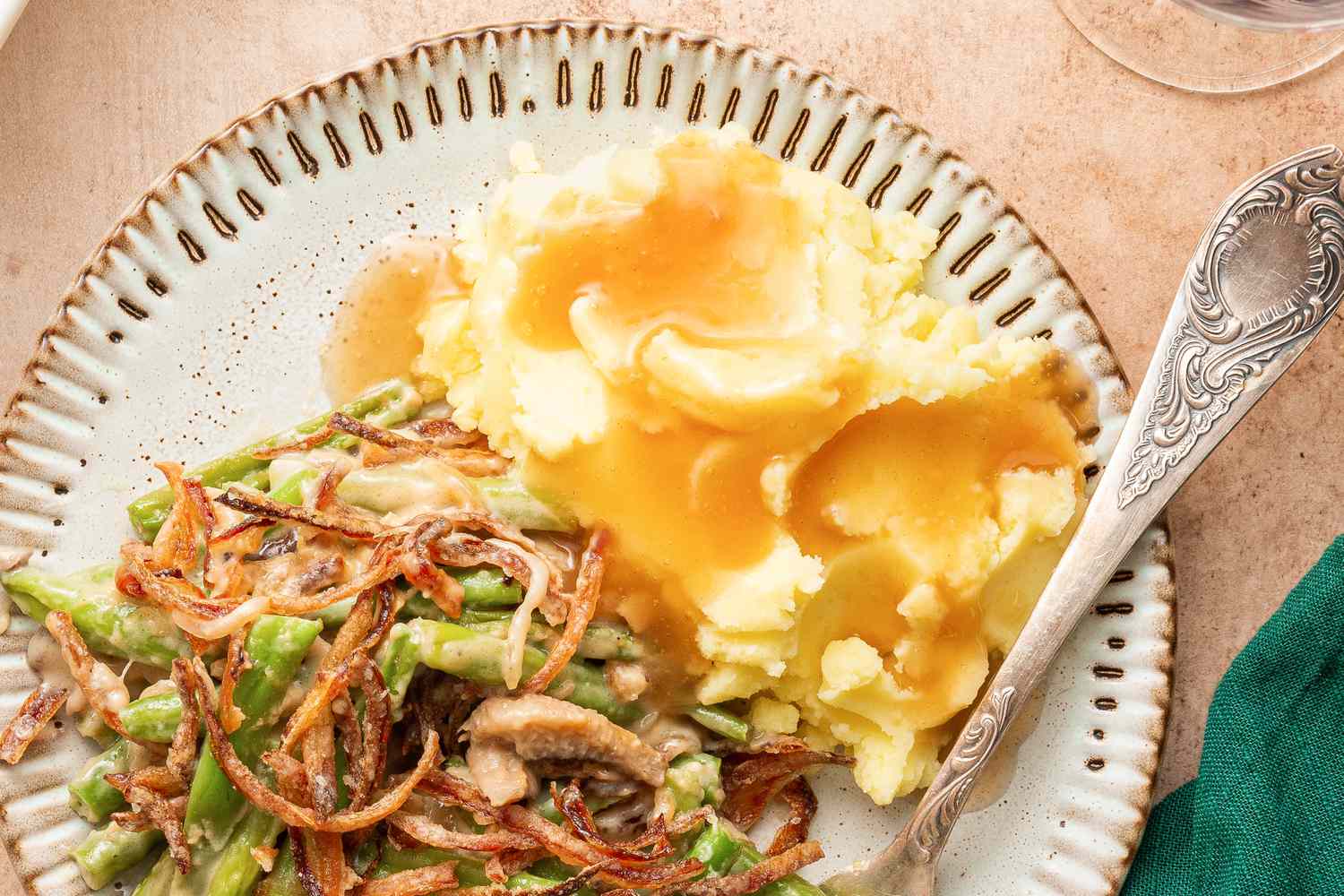 Overhead view of a plate of green bean casserole and mashed potatoes with gravy