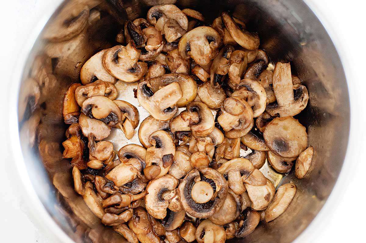 Creamy Mushroom Risotto - photograph of risotto and mushrooms inside the bowl of an instant pot