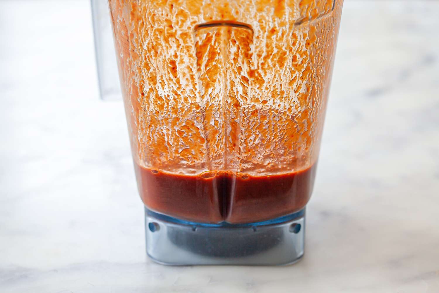 A blender with mexican hot sauce inside.