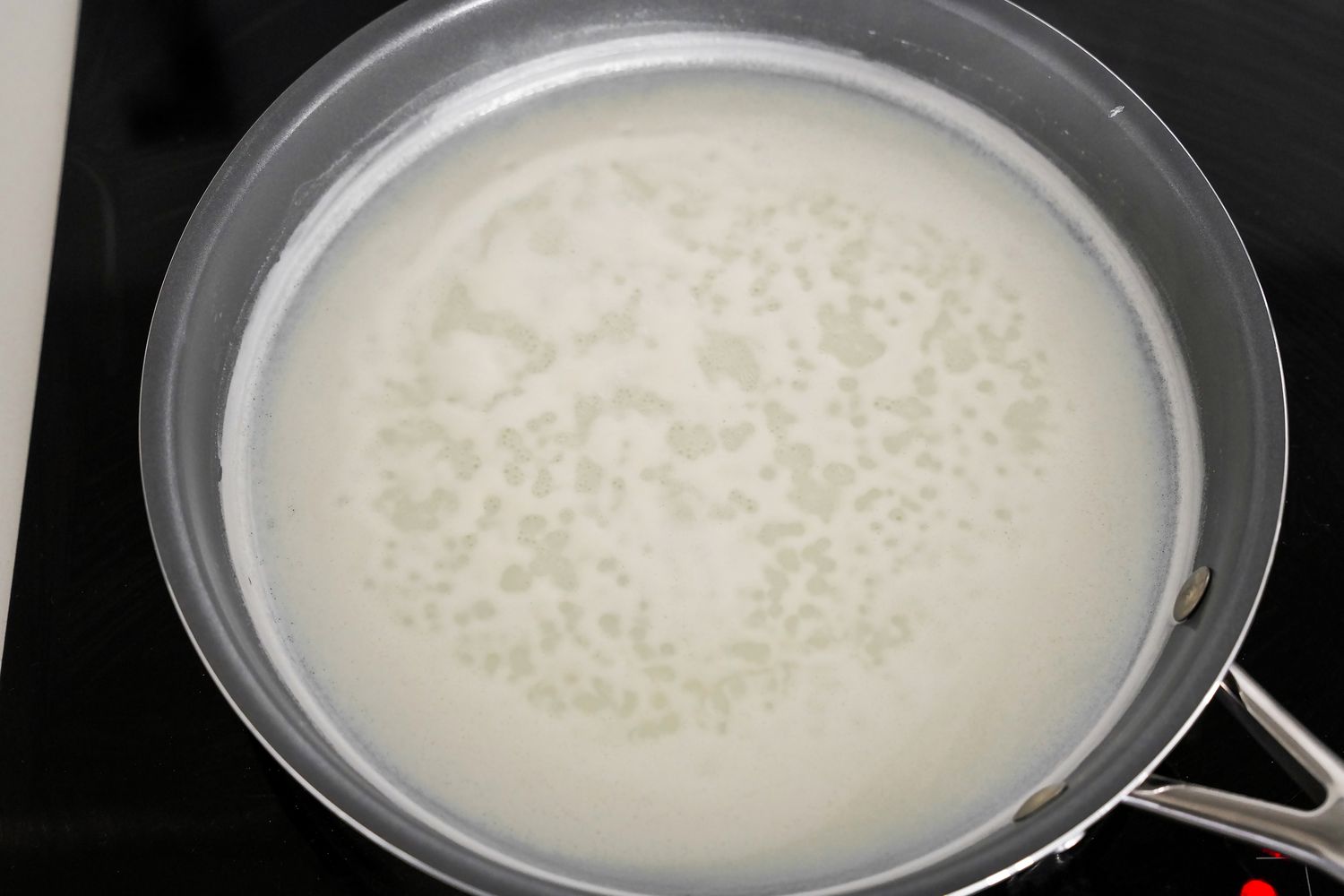 Homemade Condensed Milk Mixture Boiling in a Pan on a Stove