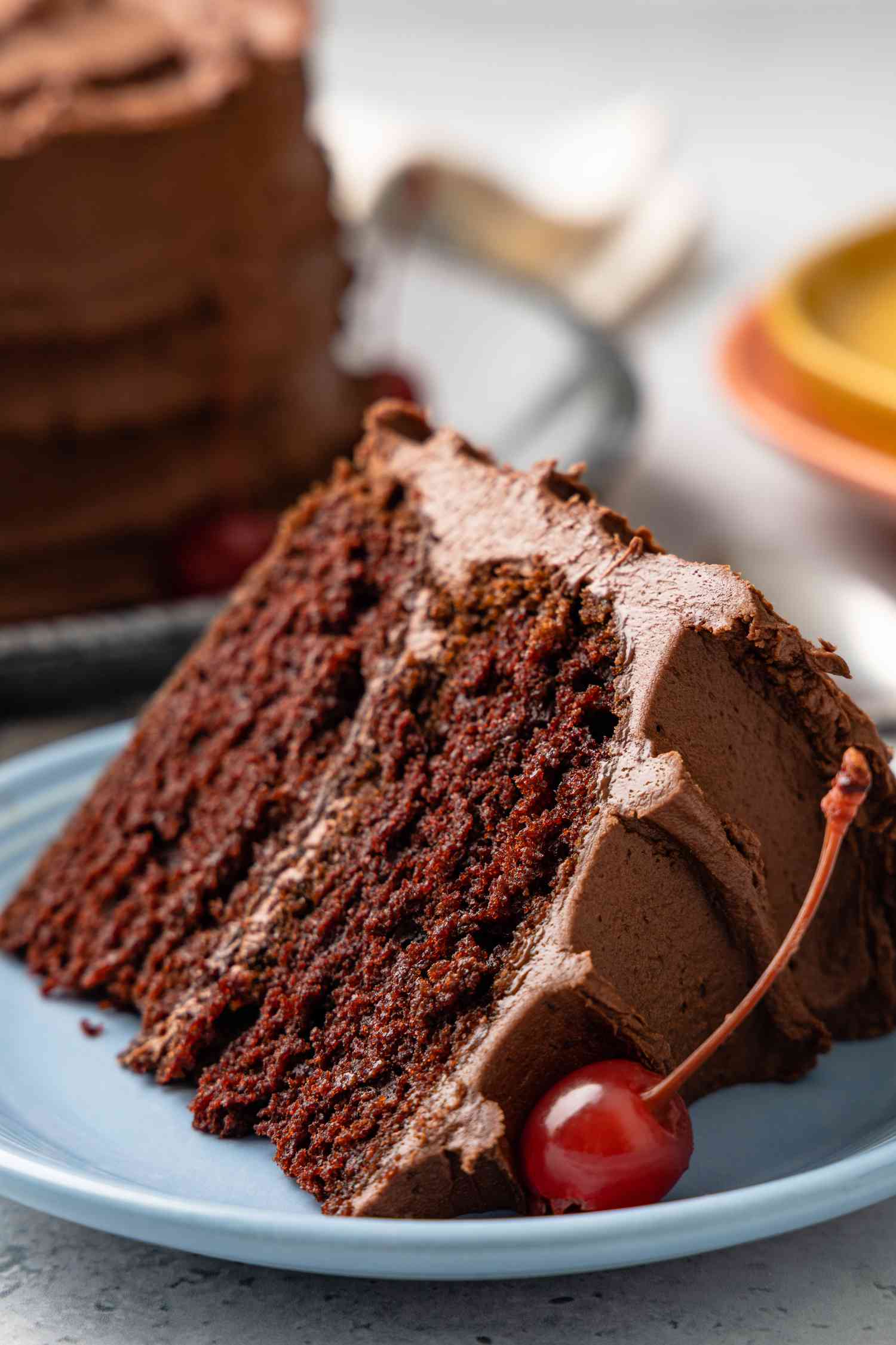 Slice of One-Bowl Double-Layer Chocolate Cake on a Small Plate with a Maraschino Cherry