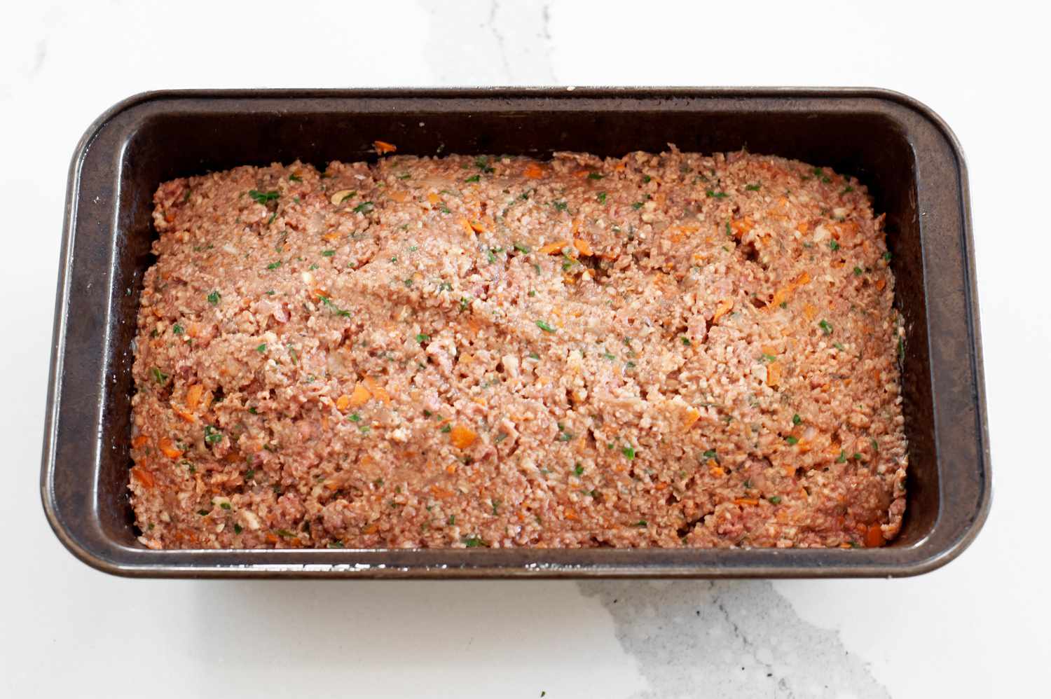 Vegetarian Meatloaf Added to a Loaf Pan 