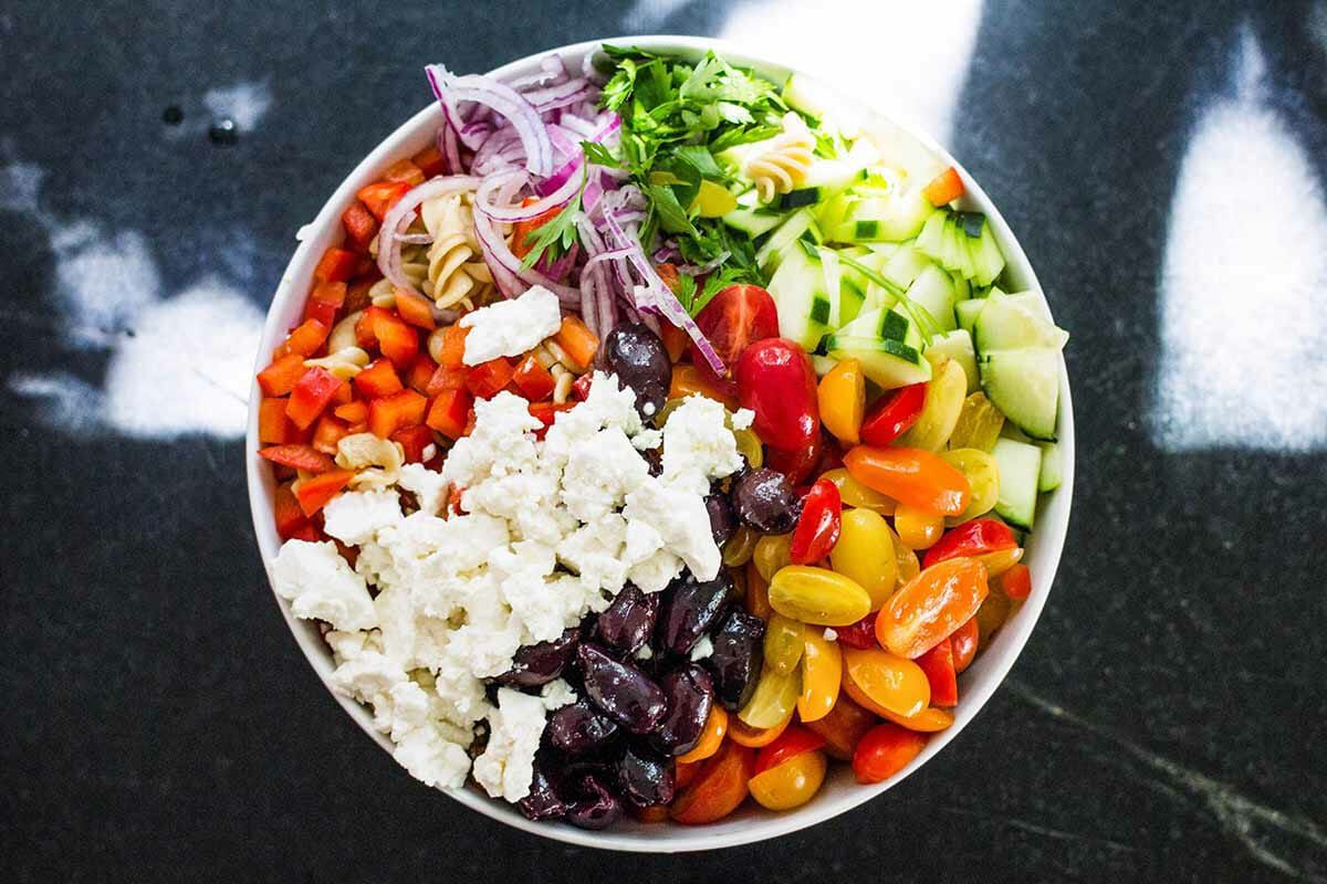 Greek Pasta Salad with Feta combine the salad ingredients