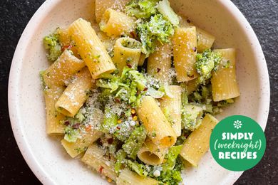A bowl of pasta with broccoli and a green Simply Recipes tag