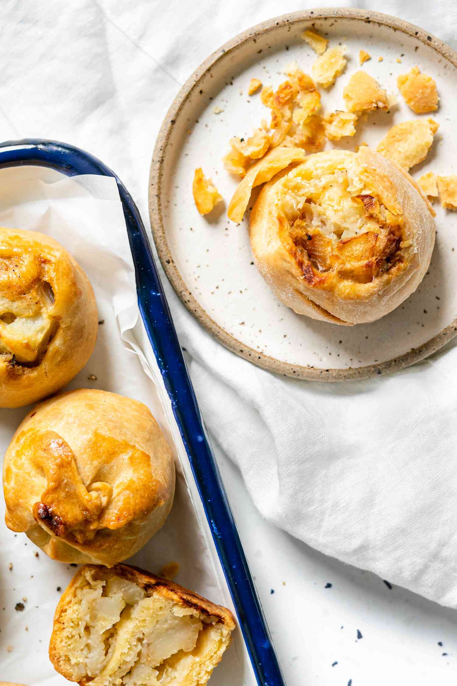 Potato Knishes on a Tray with One on a Small Plate
