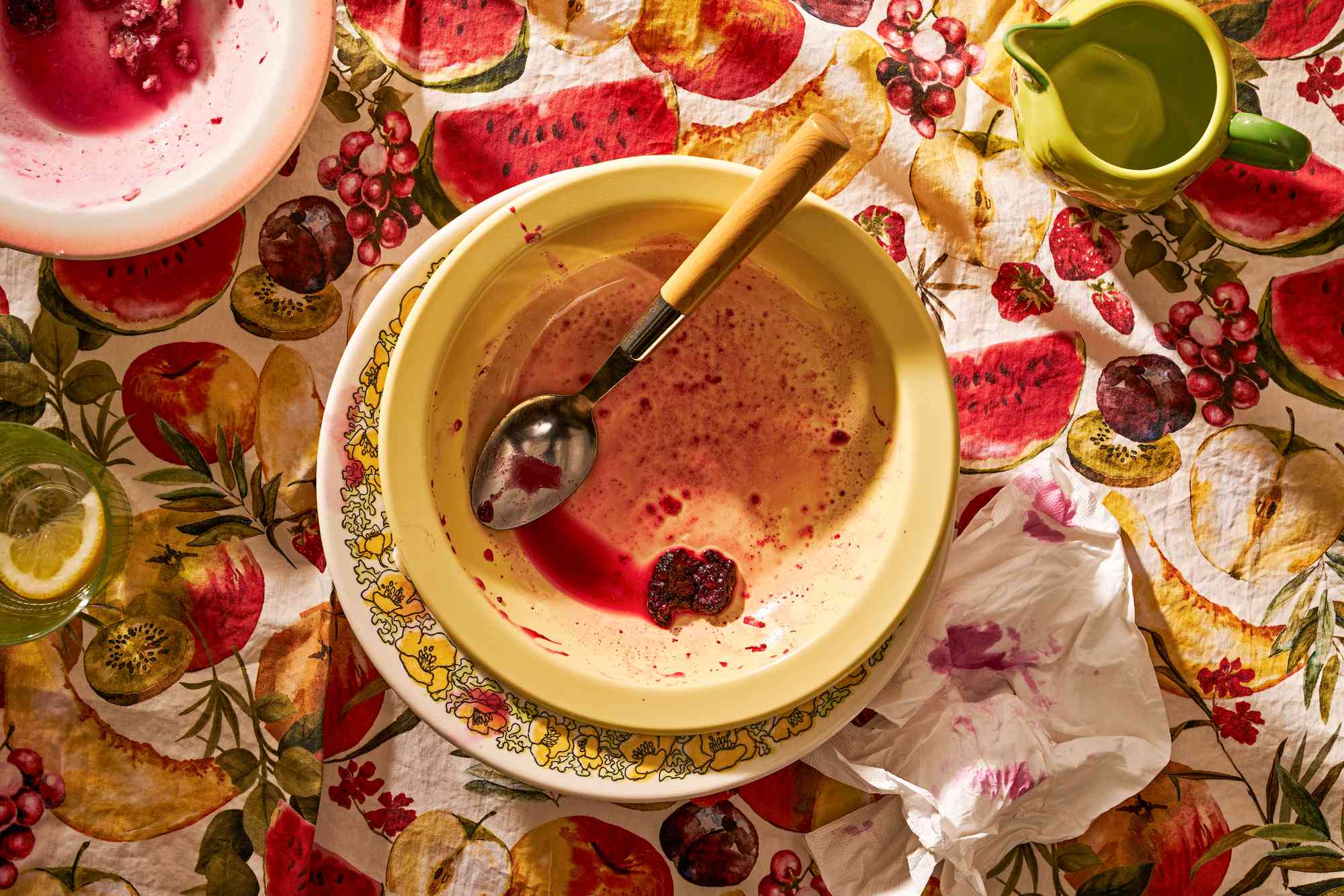 Empty bowls on a summer table containing remainders of some berry cobbler