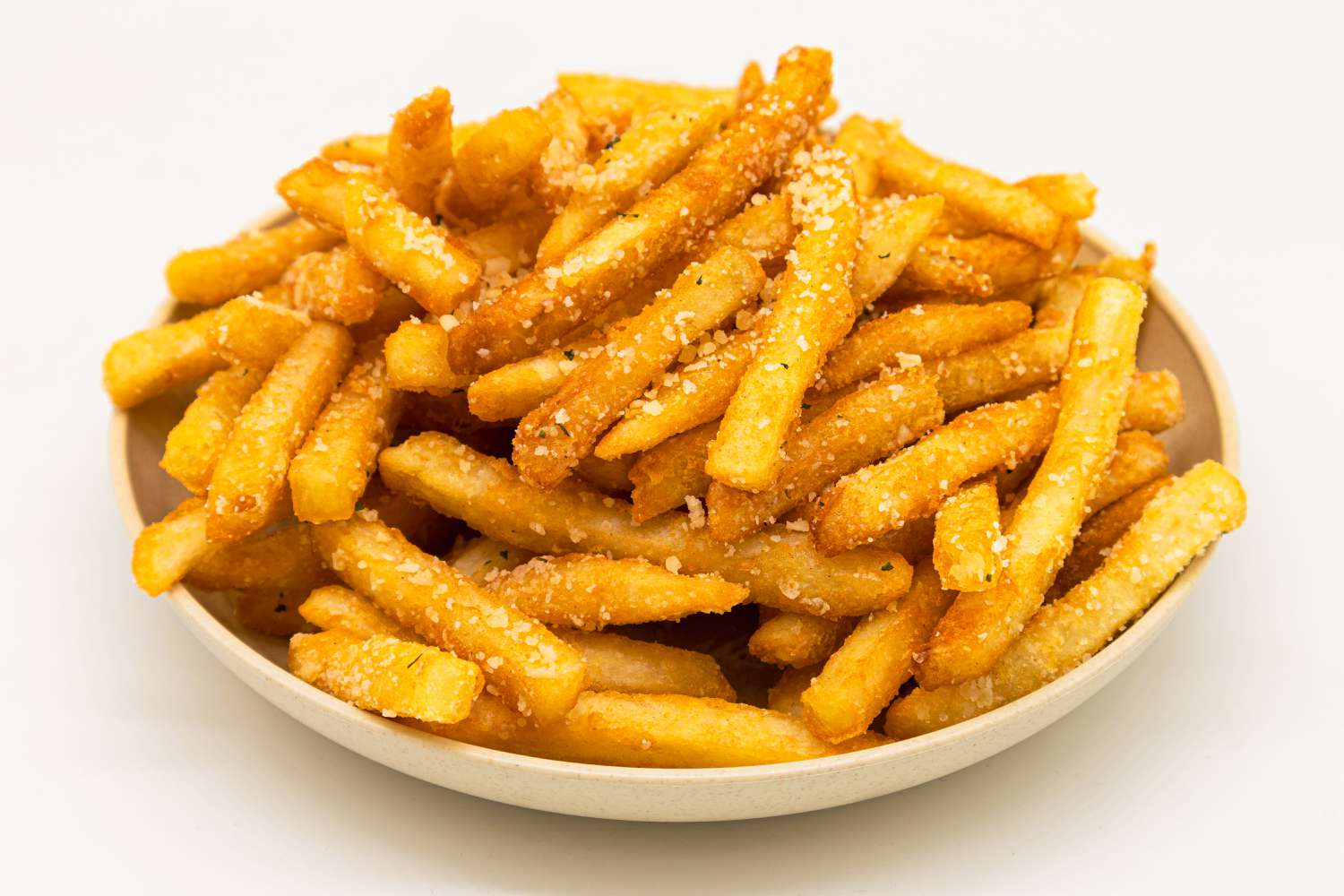 Side view of a bowl with a pile of crispy French fries