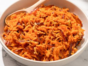 Shredded Carrot Salad in a large bowl with a wooden spoon