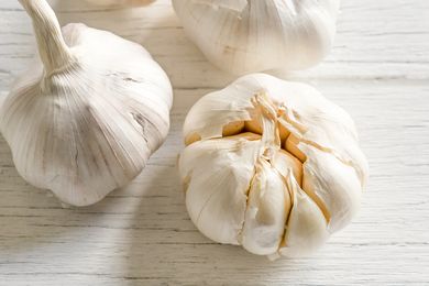 Garlic bulbs on a white wooden counter