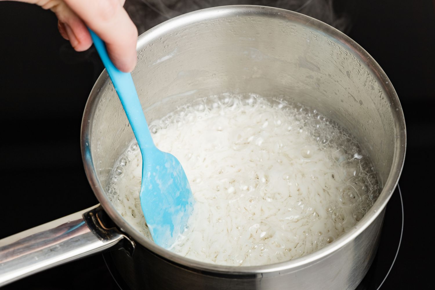 coconut cream starting to separate in the pan for biko (Filipino sticky rice cake) recipe