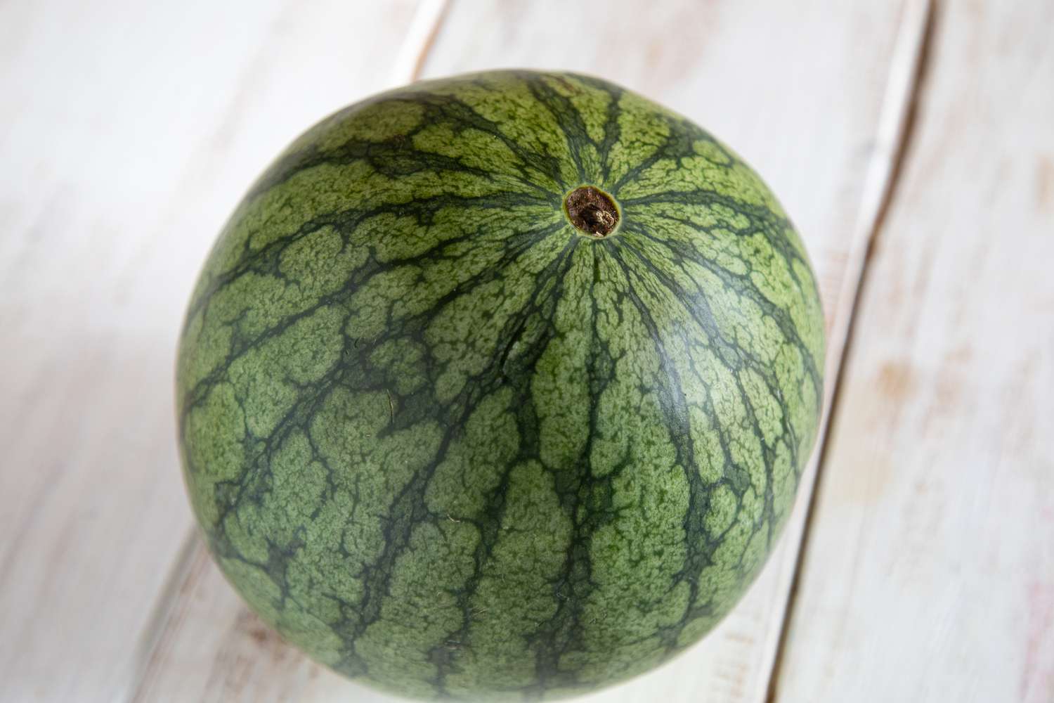 A ripe watermelon has a brown stem.