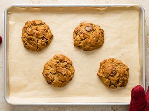 Four big chocolate chip cookies baked on Nordic Ware sheet pan