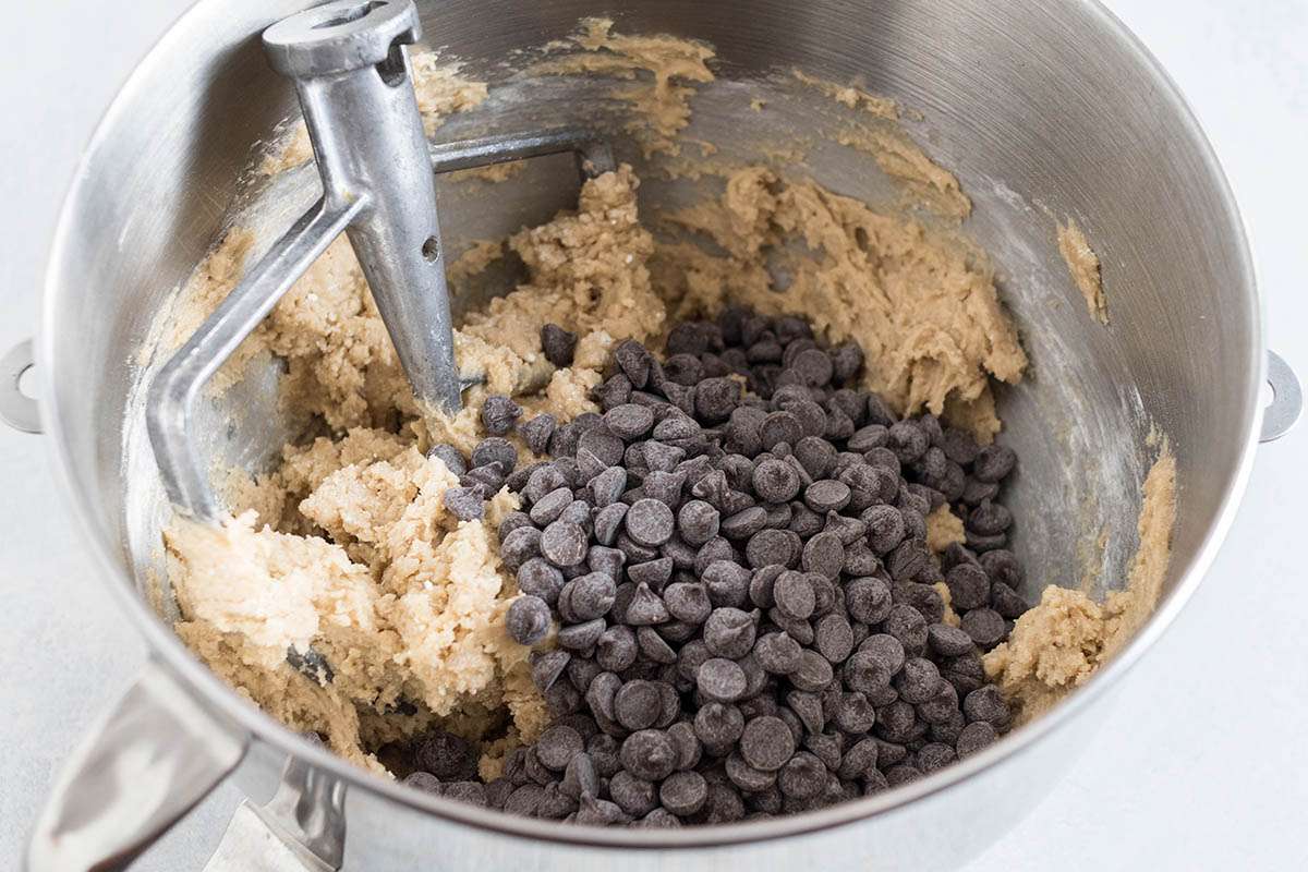 Adding chocolate chips for chocolate chip cookies.