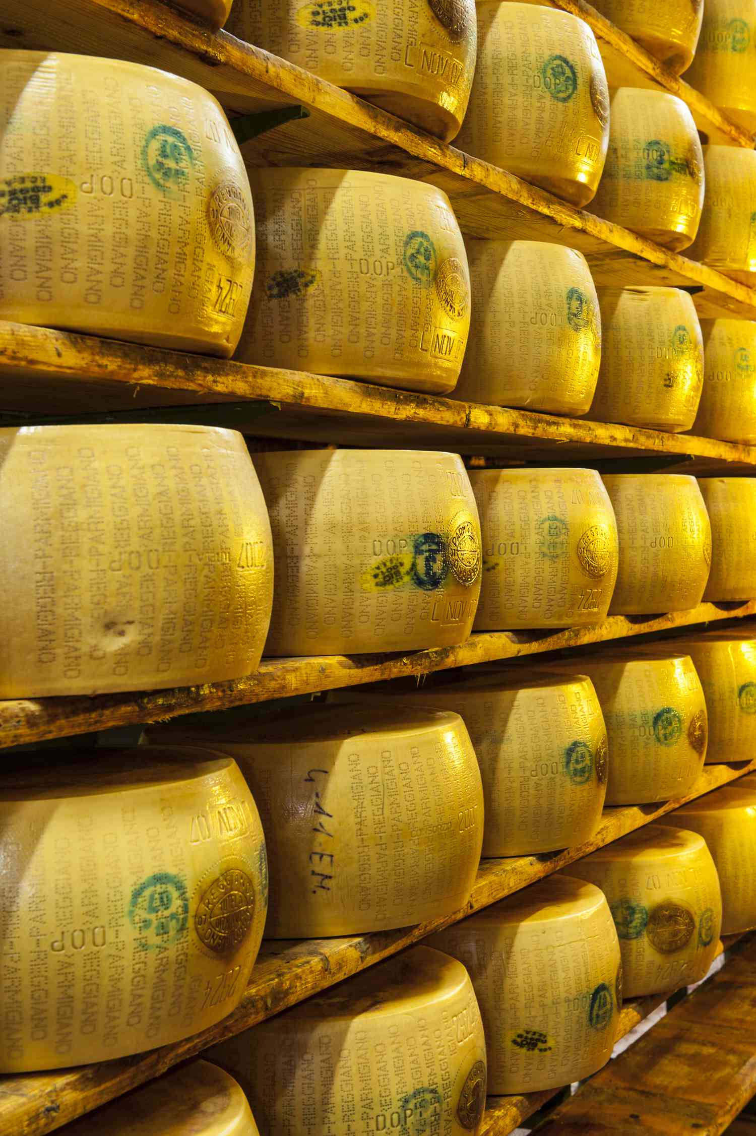Wheels of Parmigiano Reggiano on shelves