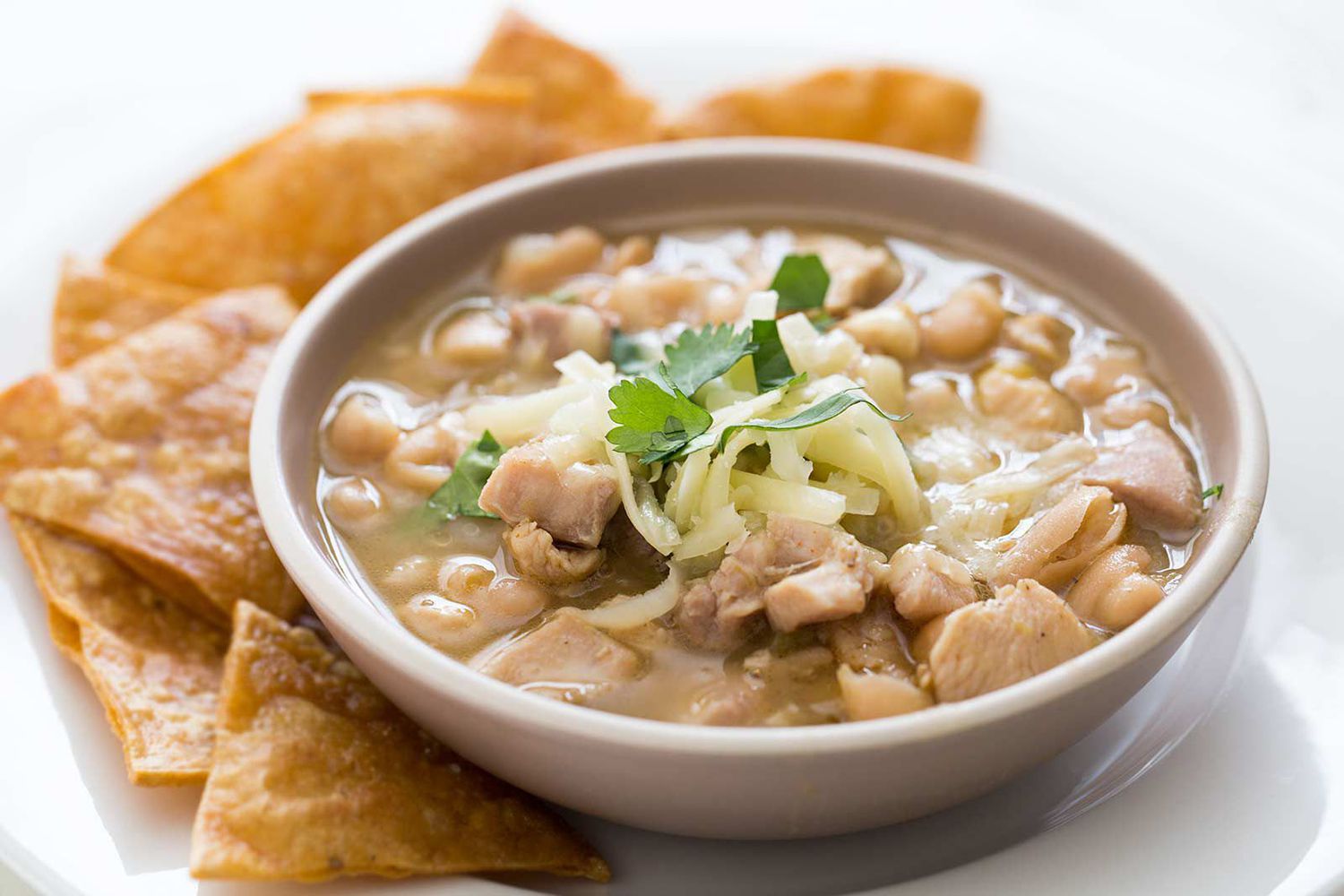 White bean chicken chili in a serving bowl with chips