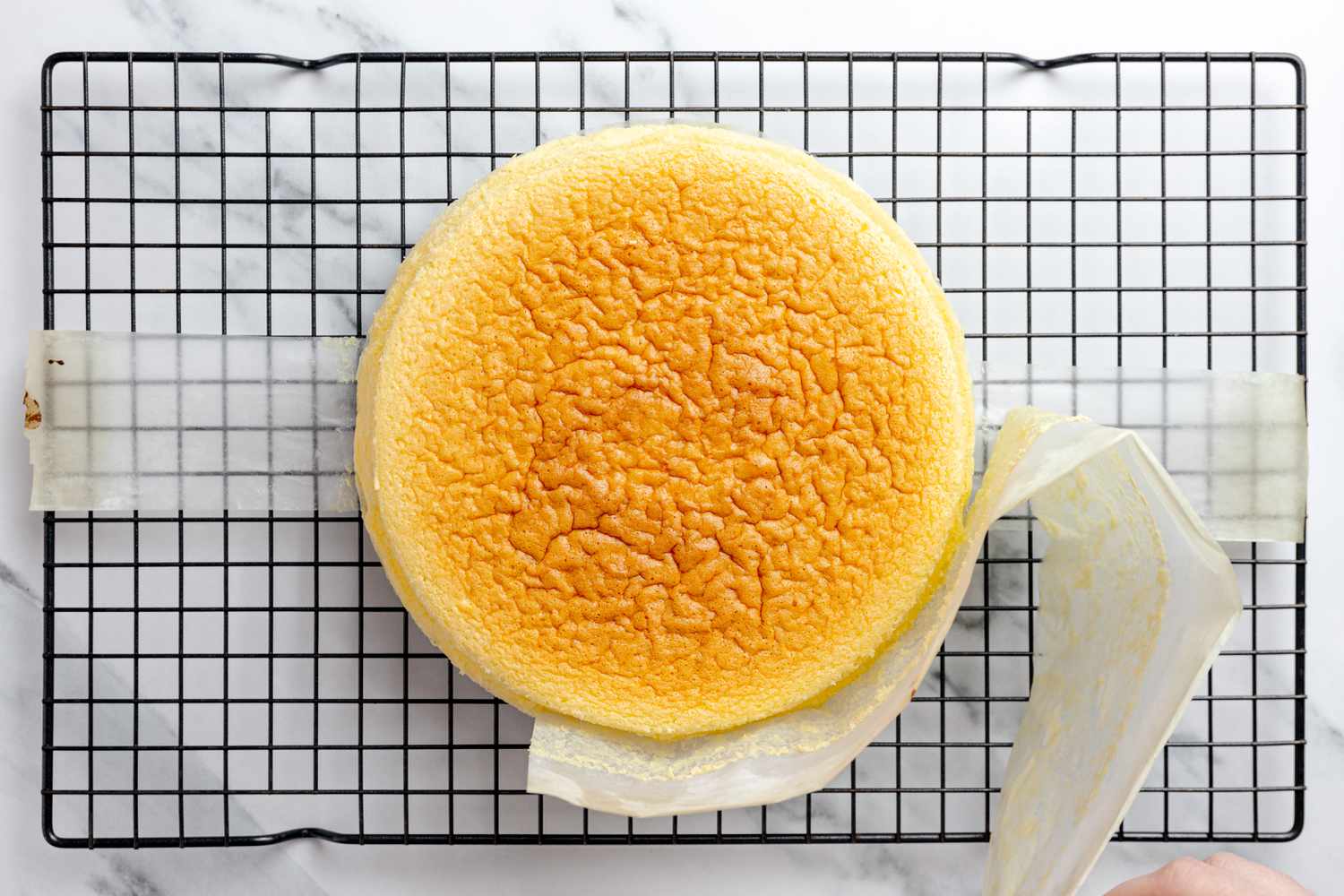 On the Cooling Rack, Parchment Paper Removed From Japanese Cheesecake After Lifted From Cake Pan