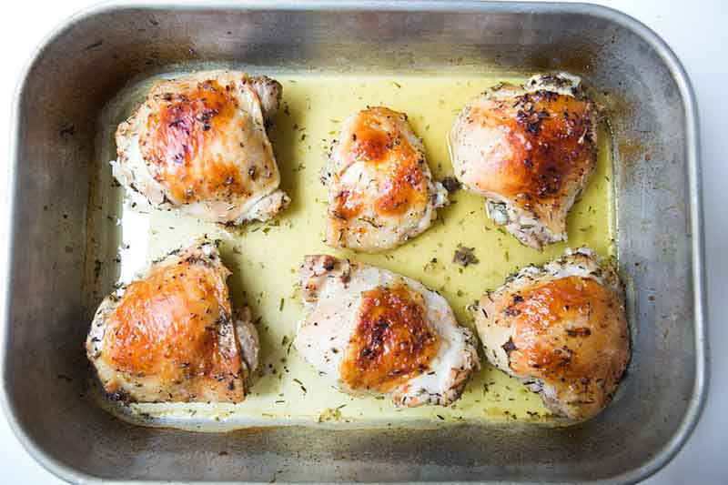 Fully cooked lemon chicken in a baking pan