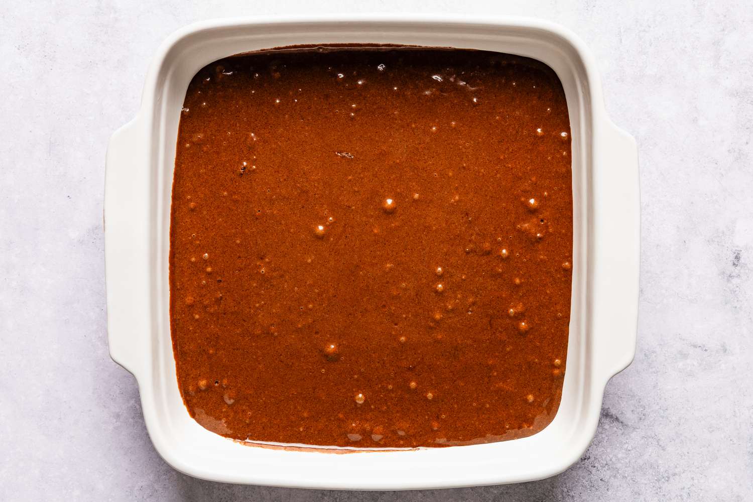 chocolate pudding cake batter in a baking pan 