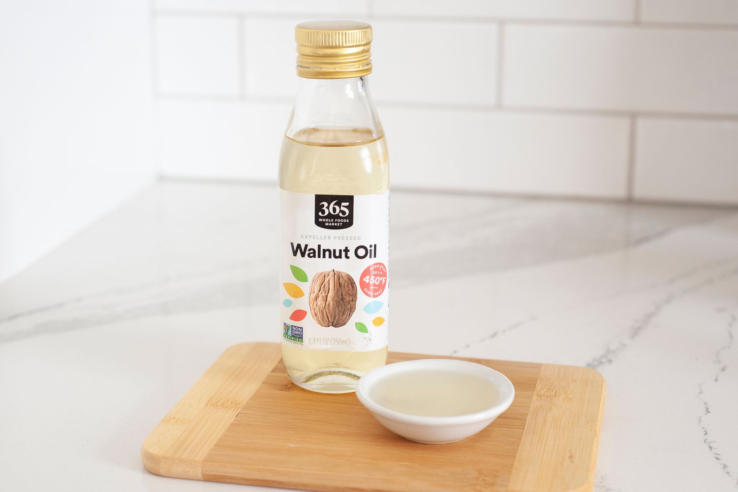 Walnut oil on wood cutting board white background