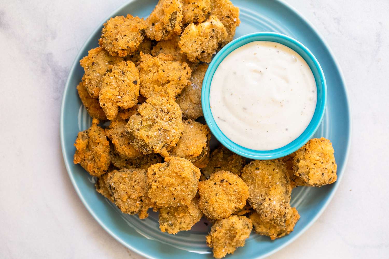 Plate of Fried Pickles Served with a Bowl of Dressing
