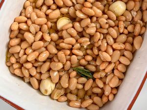 white beans with garlic and rosemary in a white casserole
