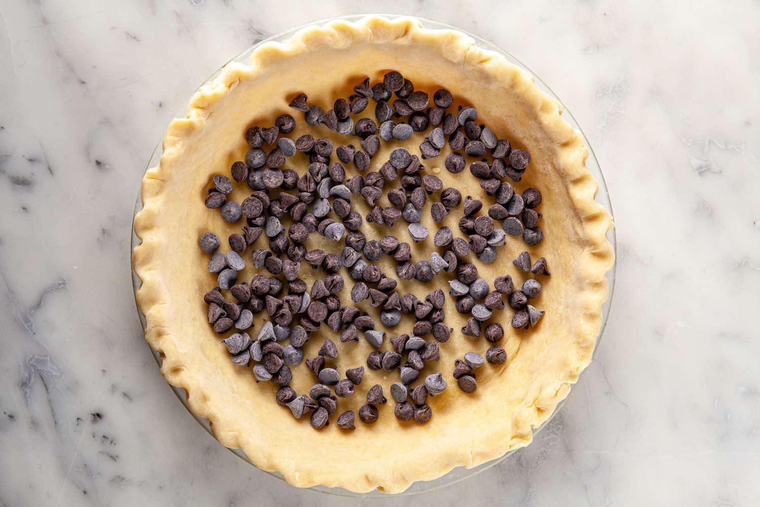 Chocolate chips in the bottom of a pie crust for chocolate pecan pie.