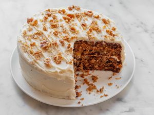 An easy carrot cake recipe with a couple slices missing from the cake.