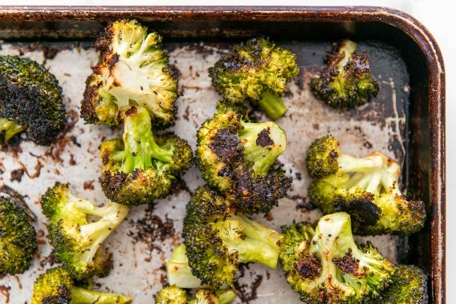 Roasted broccoli florets on a baking tray