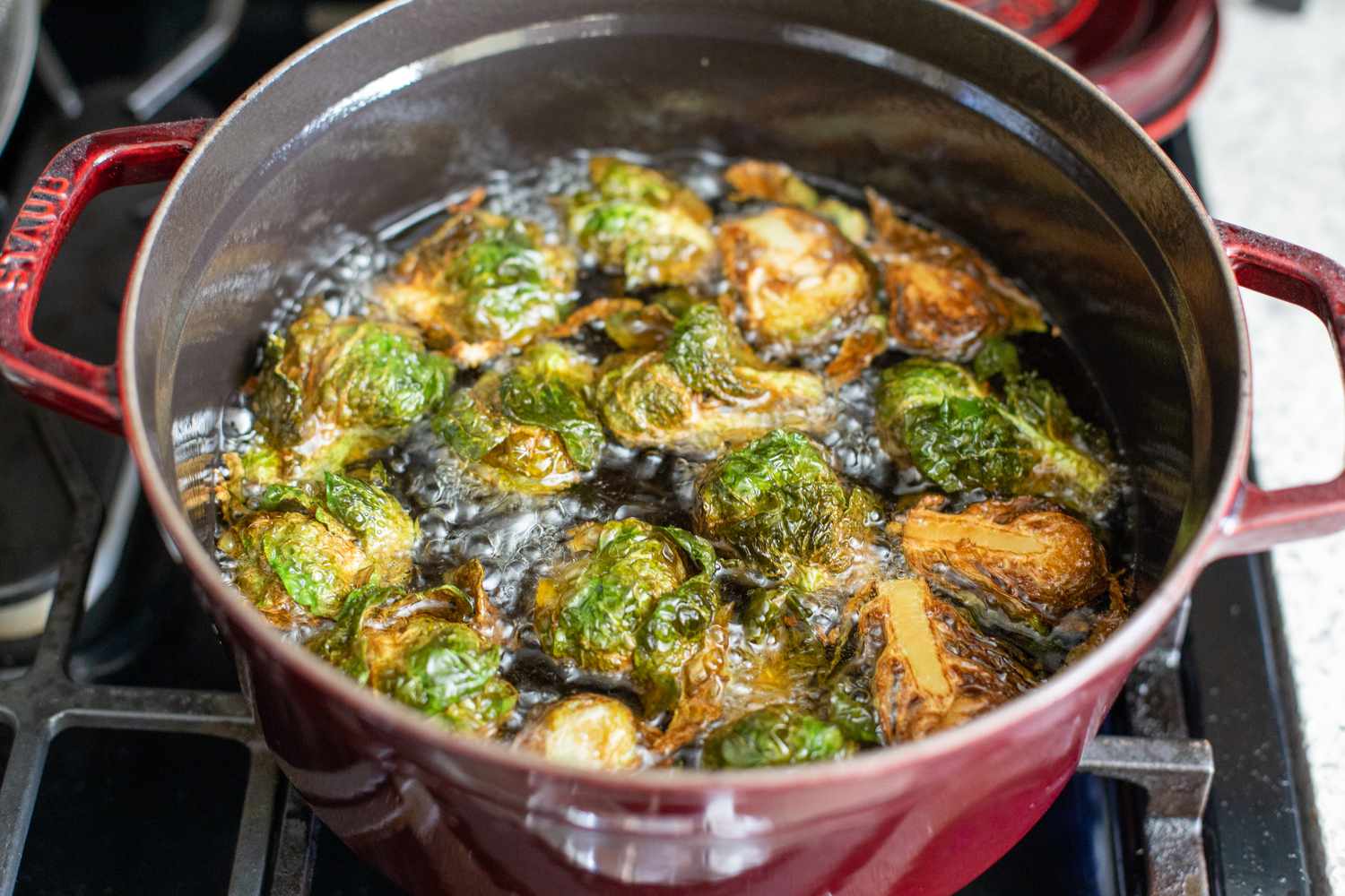 Brussel Sprouts Frying in Oil in a Dutch Oven