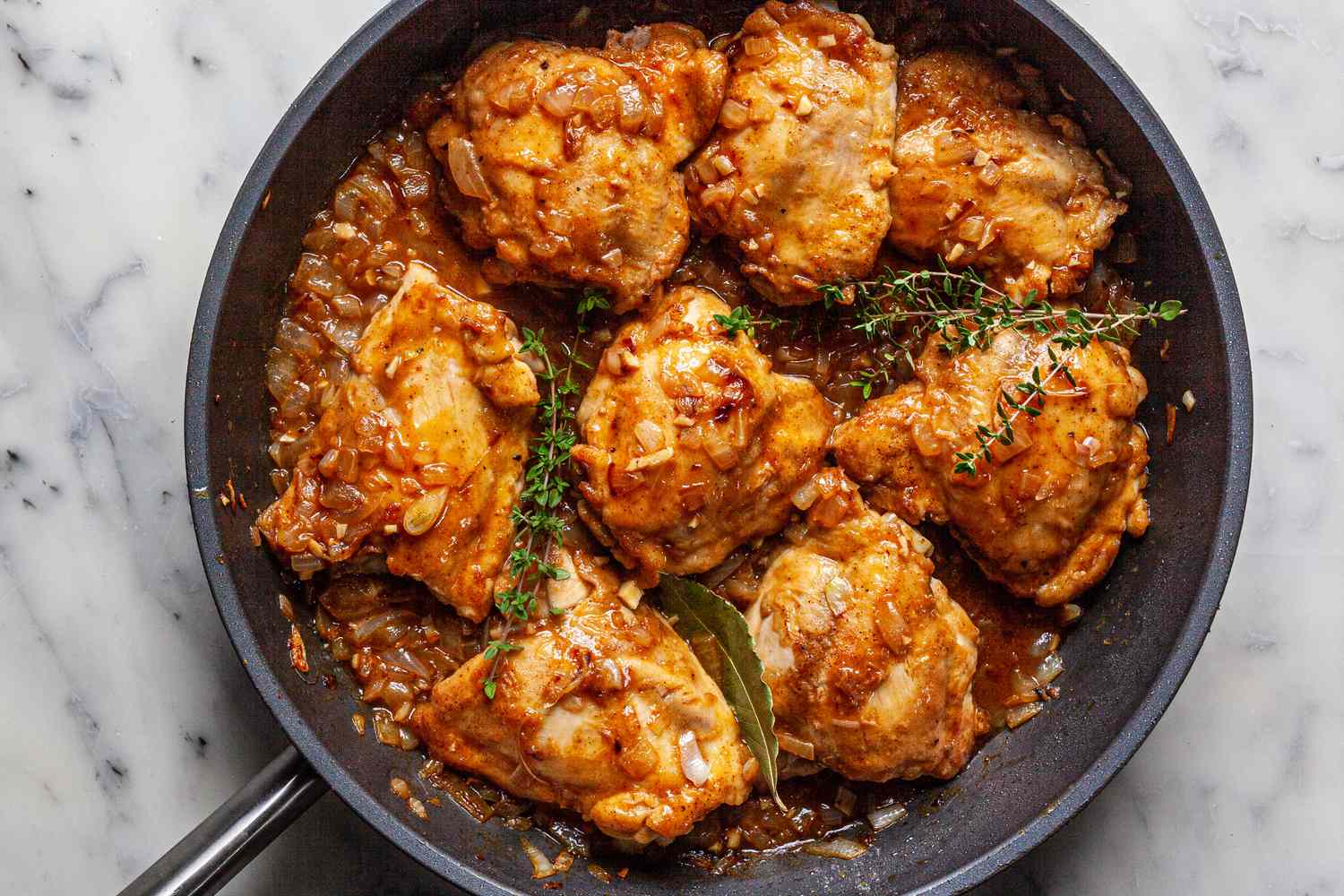 Making Southern smothered chicken recipe in a skillet.
