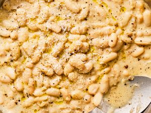 Cacio e pepe white beans with grated cheese on top