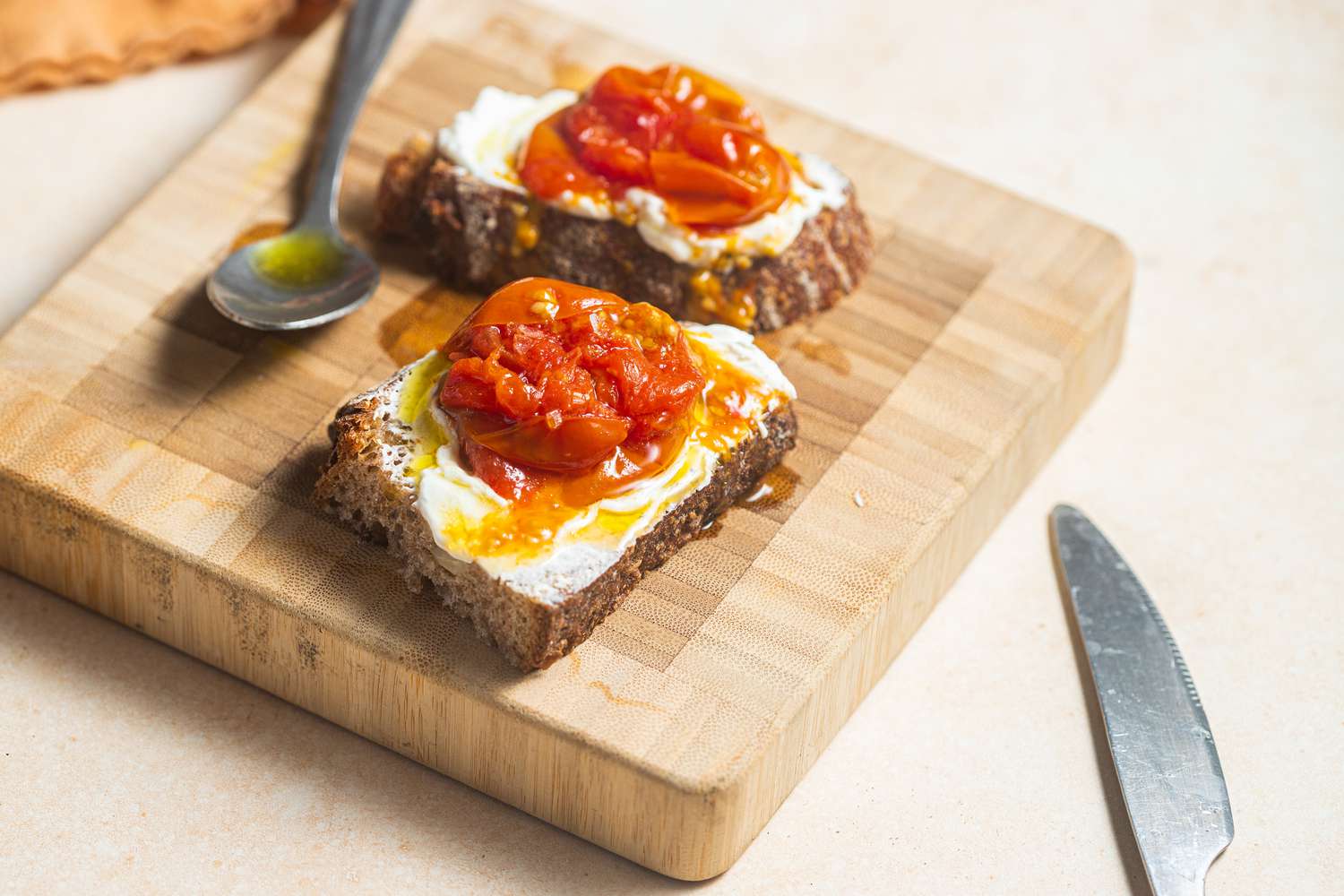 Tomato Confit Spread on Toast on a Cutting Board 