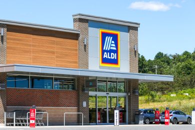 The entrance and exterior of an Aldi grocery store showing signage and parking area