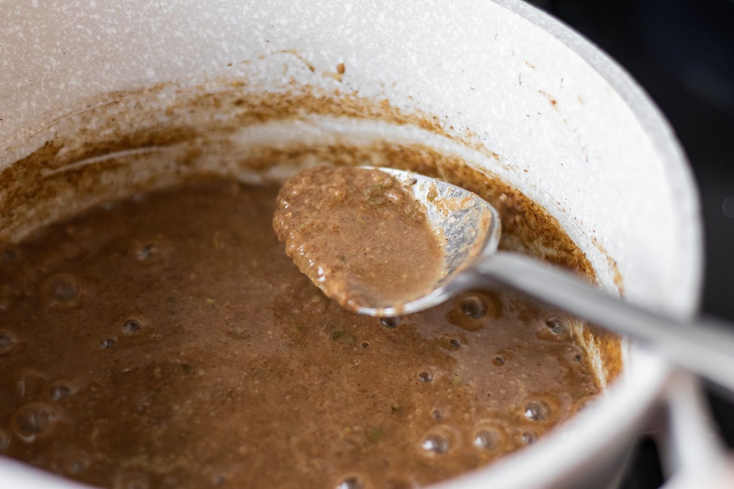 A pot of of gravy that shows how to make jerk chicken.