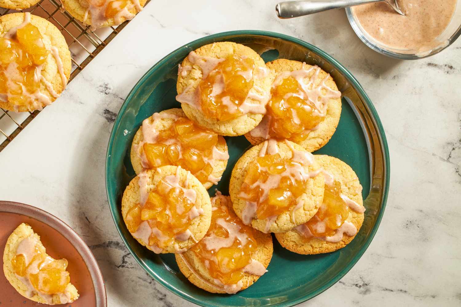 A plate of apple pie cookies with icing and filling