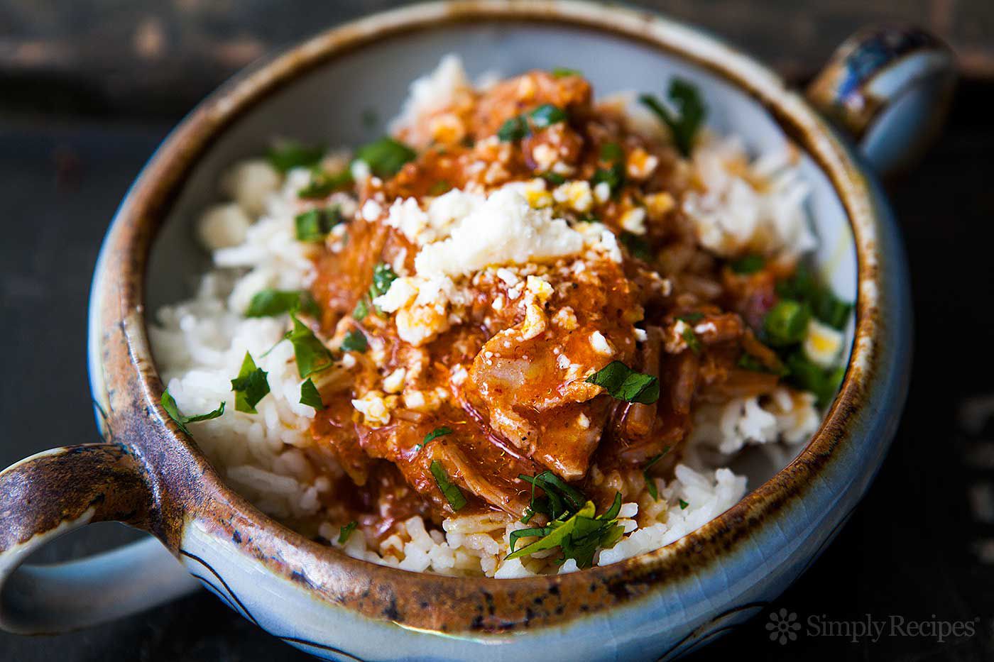 Dish of Cochinita Pibil served in a bowl with rice and garnishes