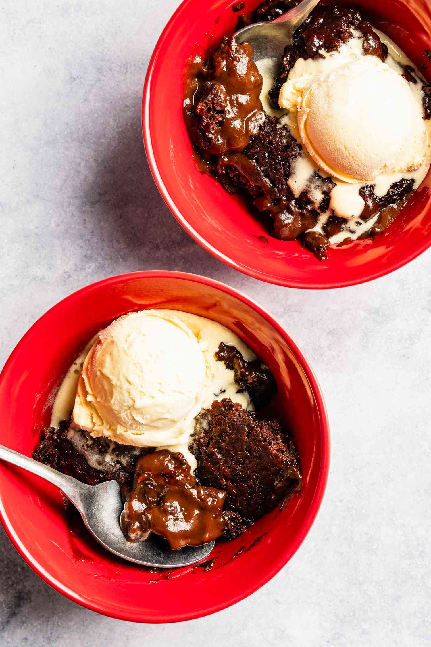 bowl of chocolate pudding cake with a scoop of vanilla ice cream
