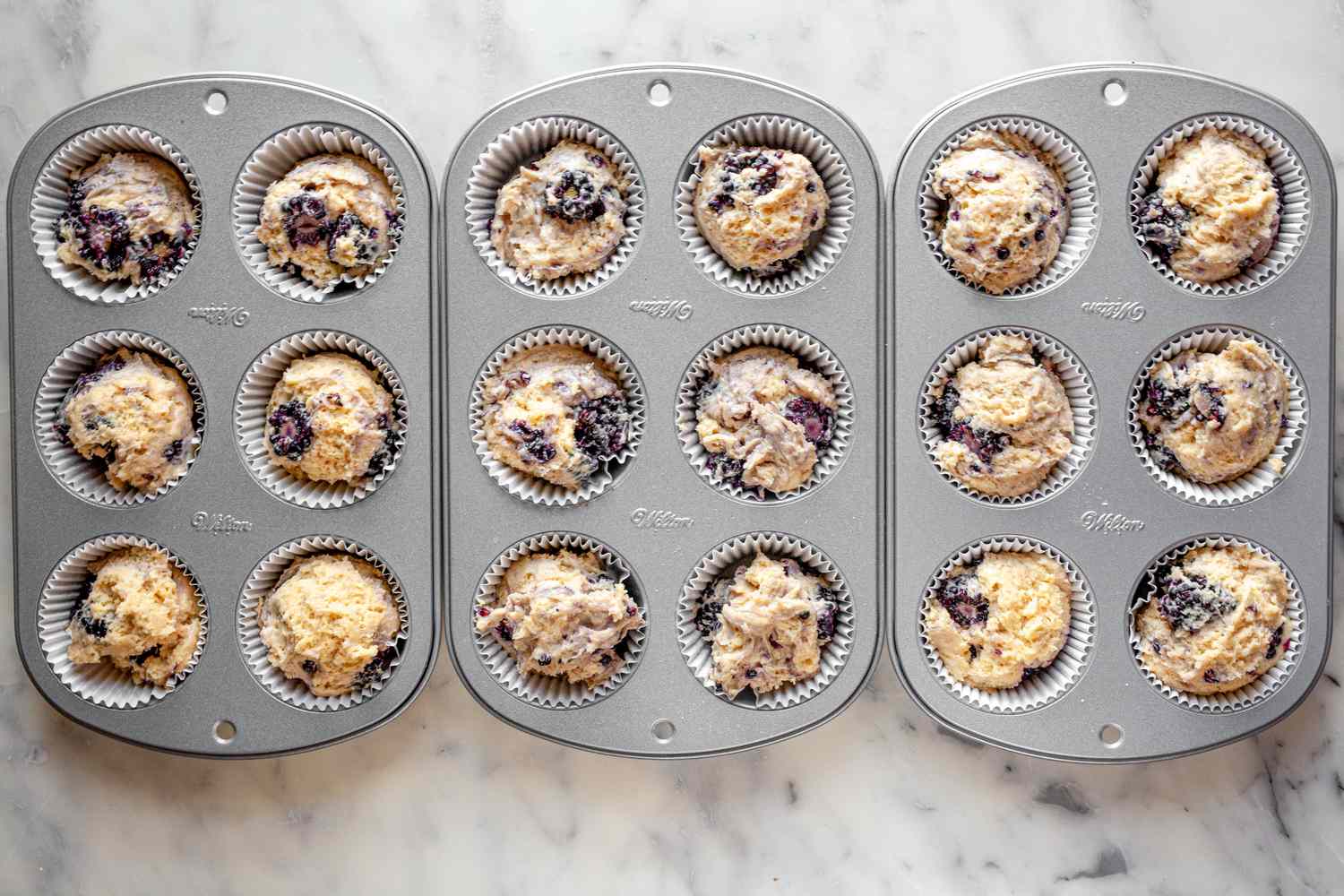 Blackberry Muffins Batter in Muffin Tin