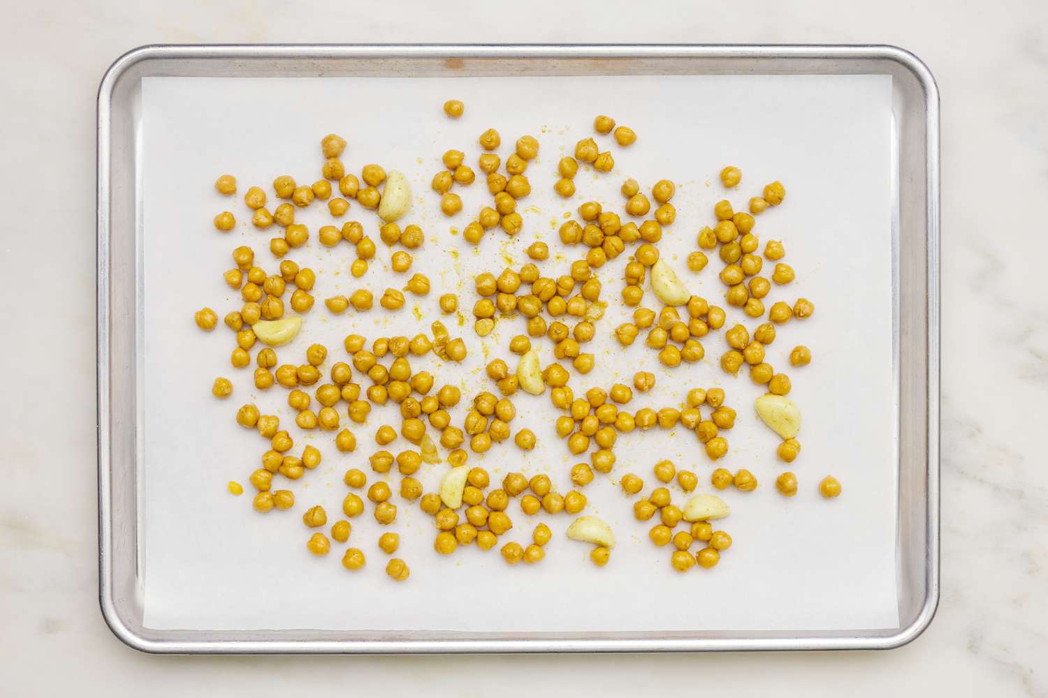 Seasoned chickpeas on a baking sheet for hummus soup recipe