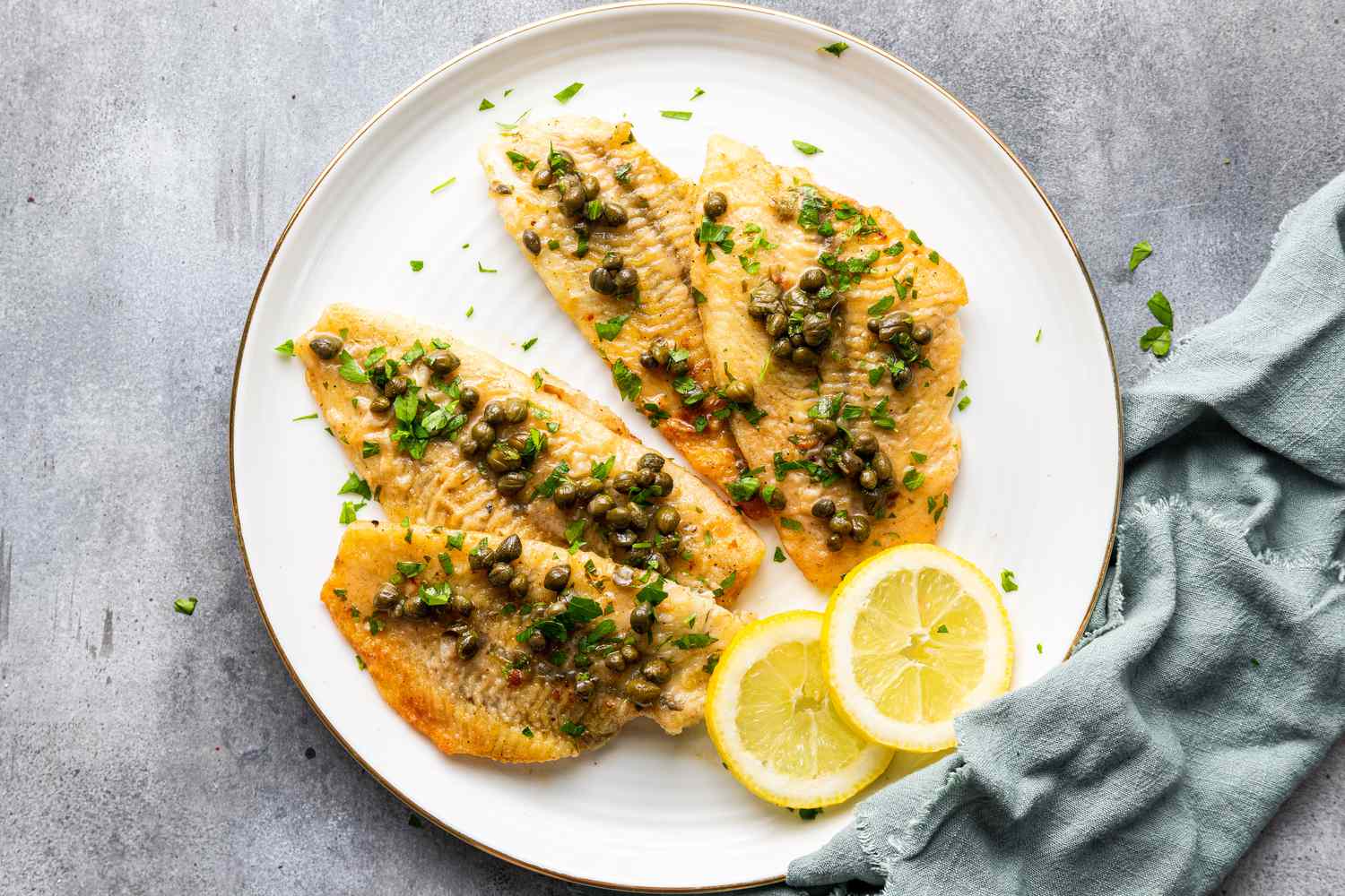 Sole Piccata with Capers and Lemon Slices on a Plate