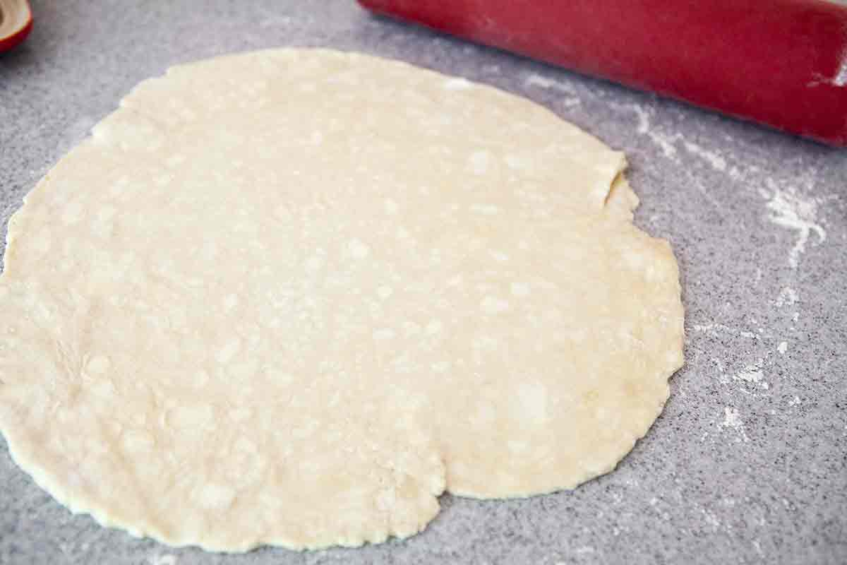 roll out the dough for peach galette