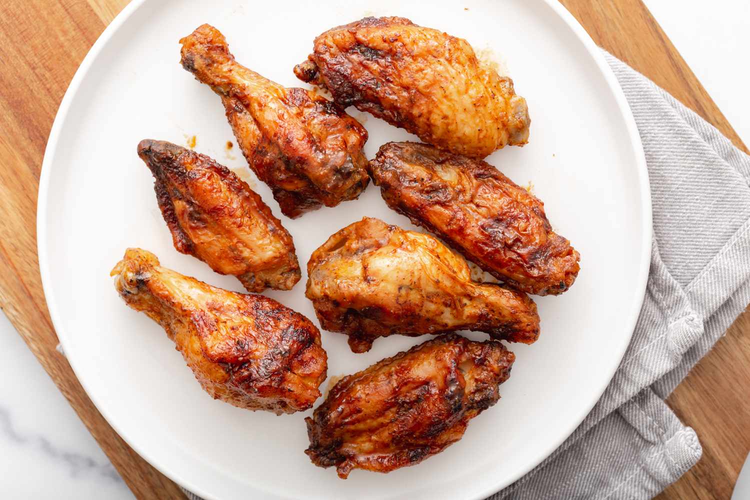 Overhead view of bbq wings on a plate.