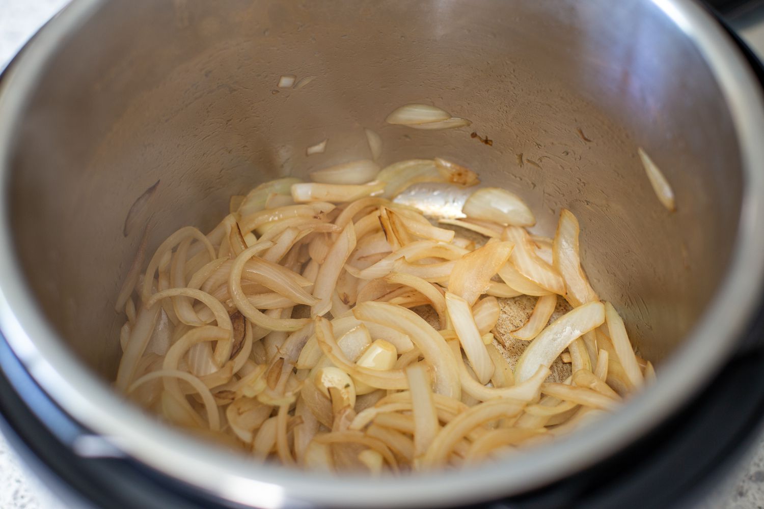 Sauteed onions in an instant pot to make quick and easy instant pot turkey breasts.