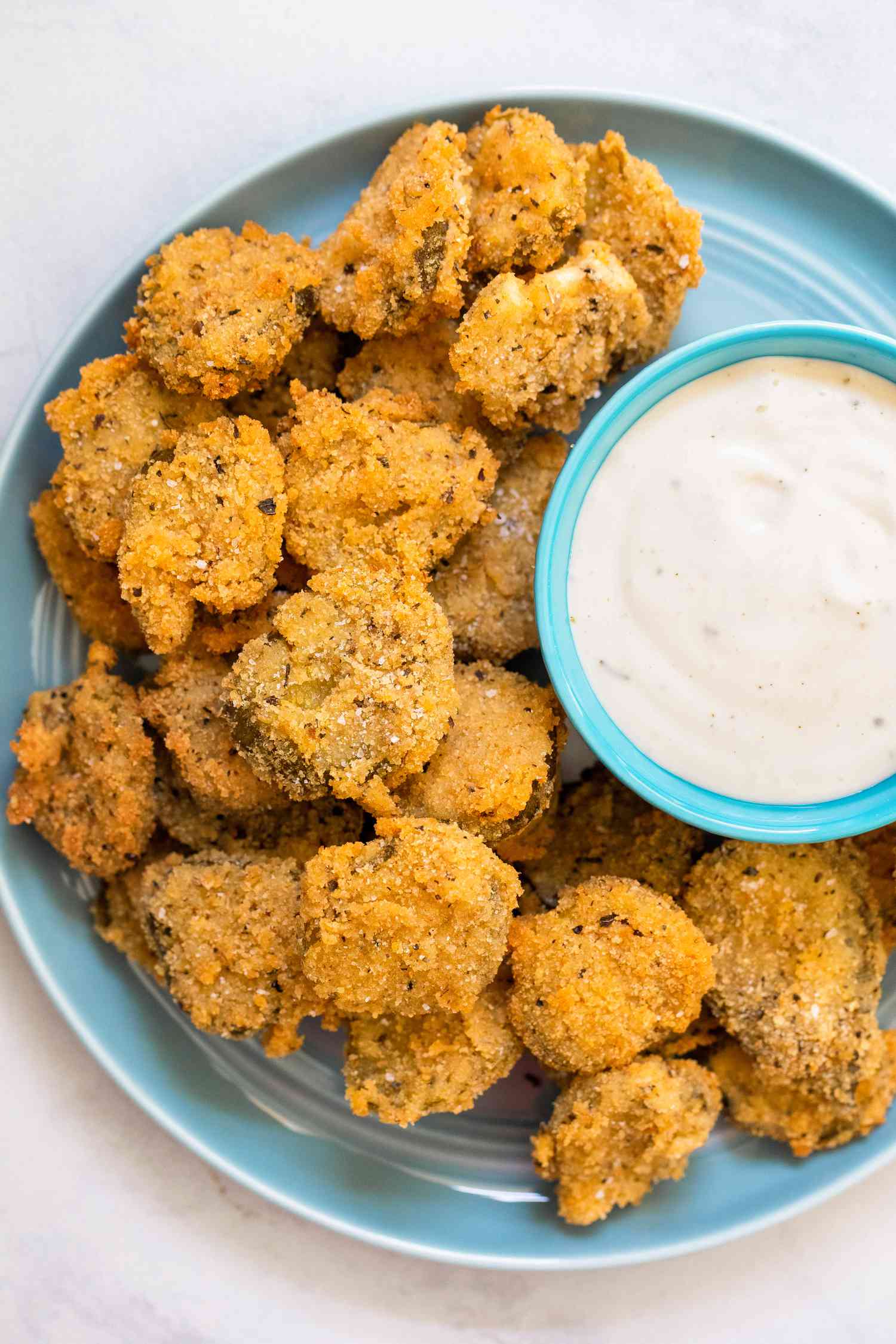 Plate of Fried Pickles Served with a Bowl of Dressing