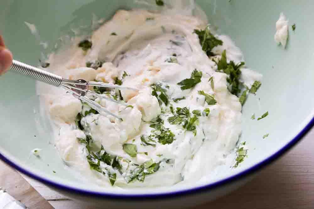 Whisk together the crema topping for Grilled Mexican Street Corn