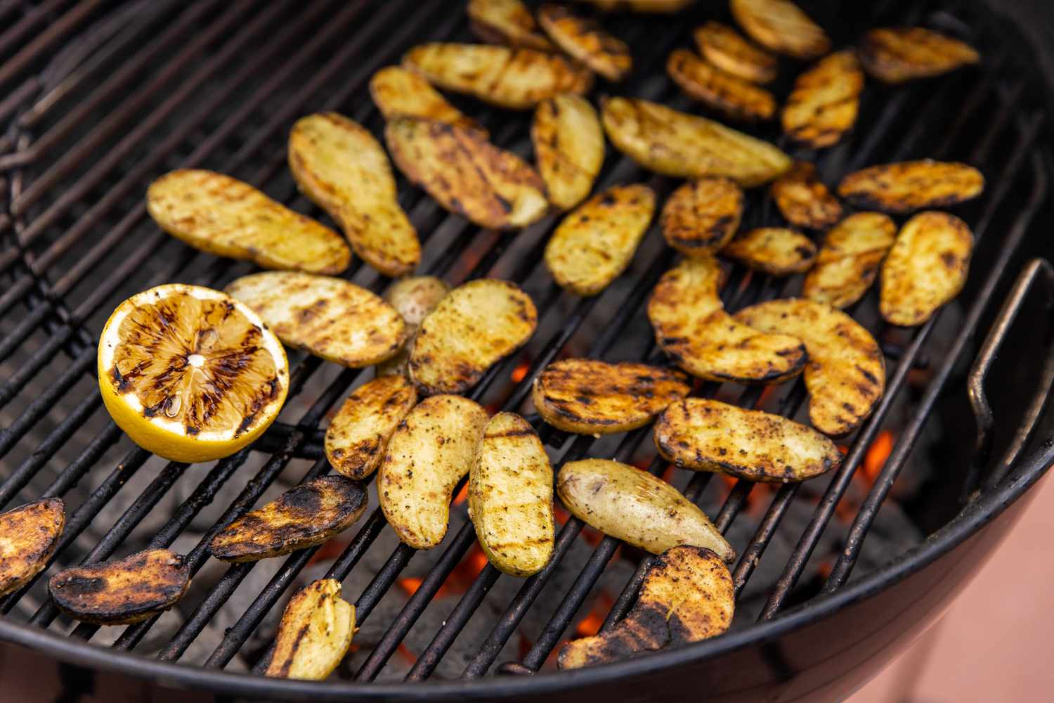 Grilled Potatoes and a Halved Lemon on the Grill 