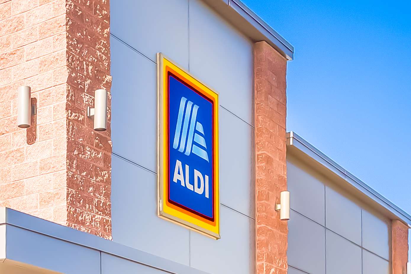 The sign for an Aldi store on the side of a building